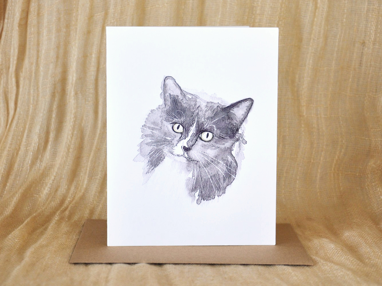 KatrinaDawn watercolour and ink pet portrait card of Kotty the cat, shown with a kraft paper envelope
