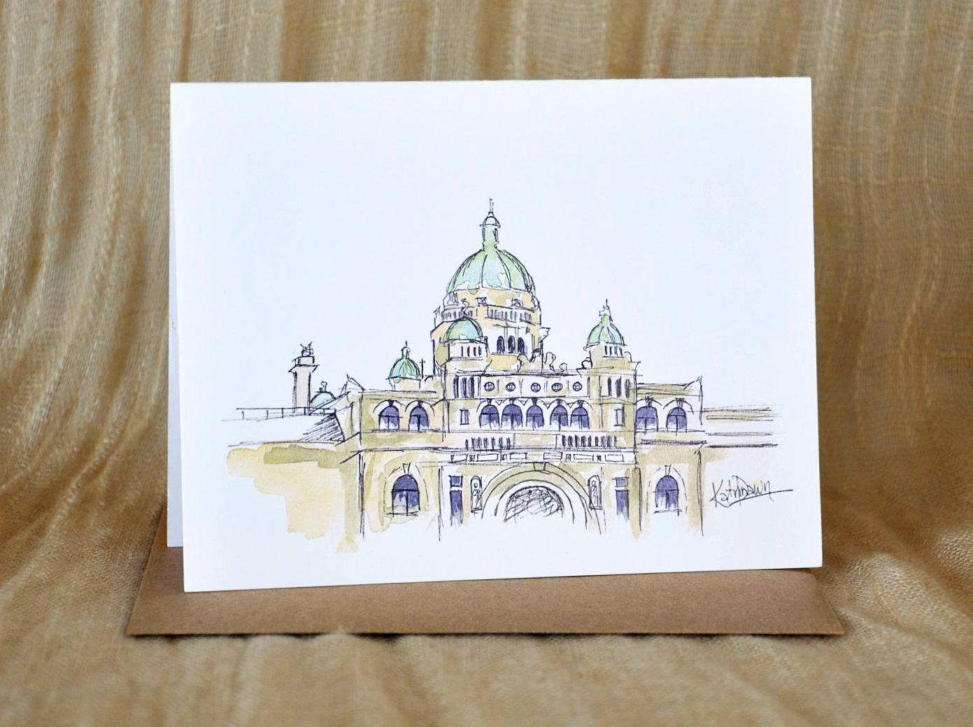KatrinaDawn watercolour and ink card of the BC Legislature Building, shown with a kraft paper envelope