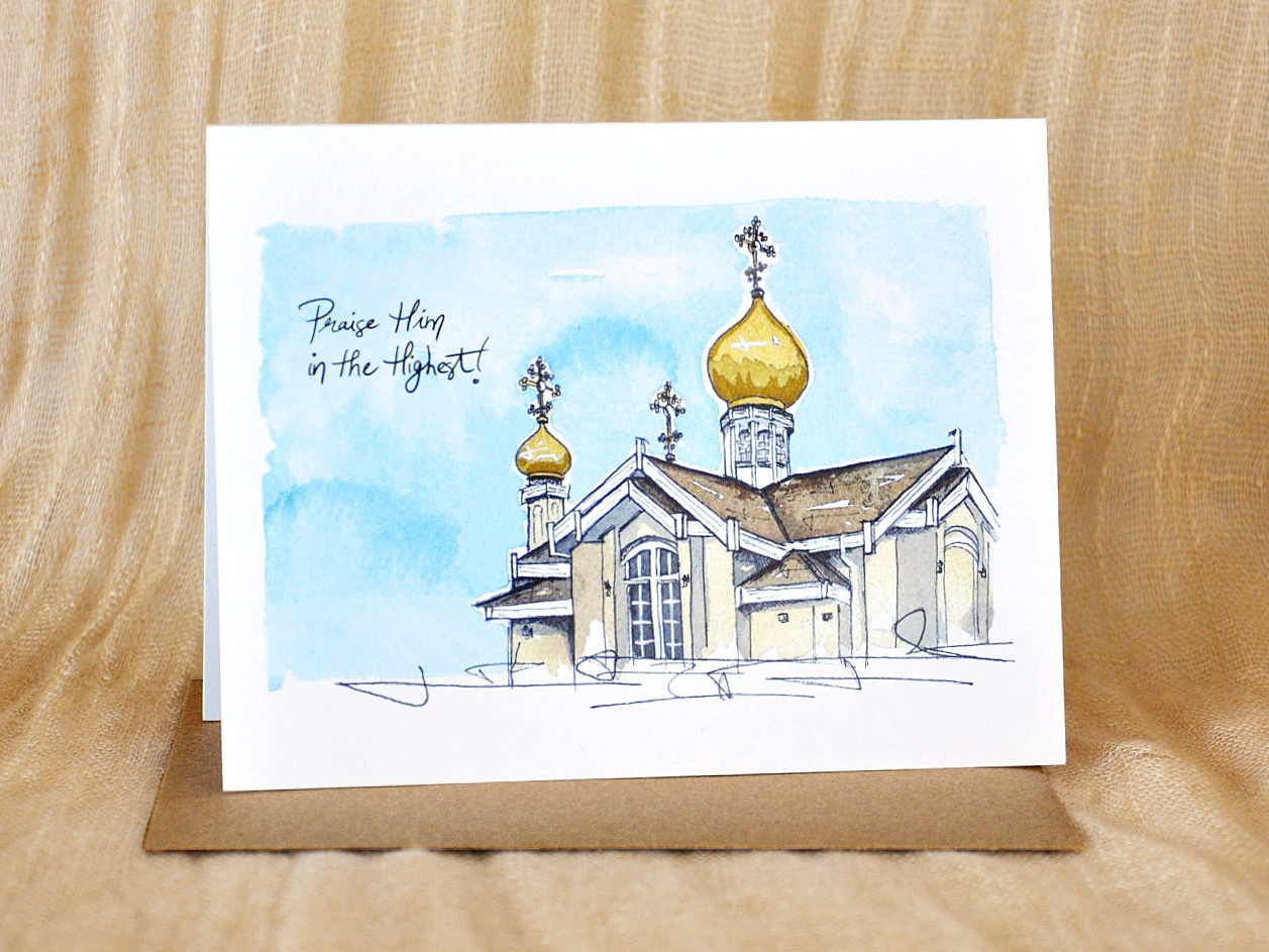 KatrinaDawn watercolour and ink card of St. Herman of Alaska Orthodox Church, shown with a kraft paper envelope